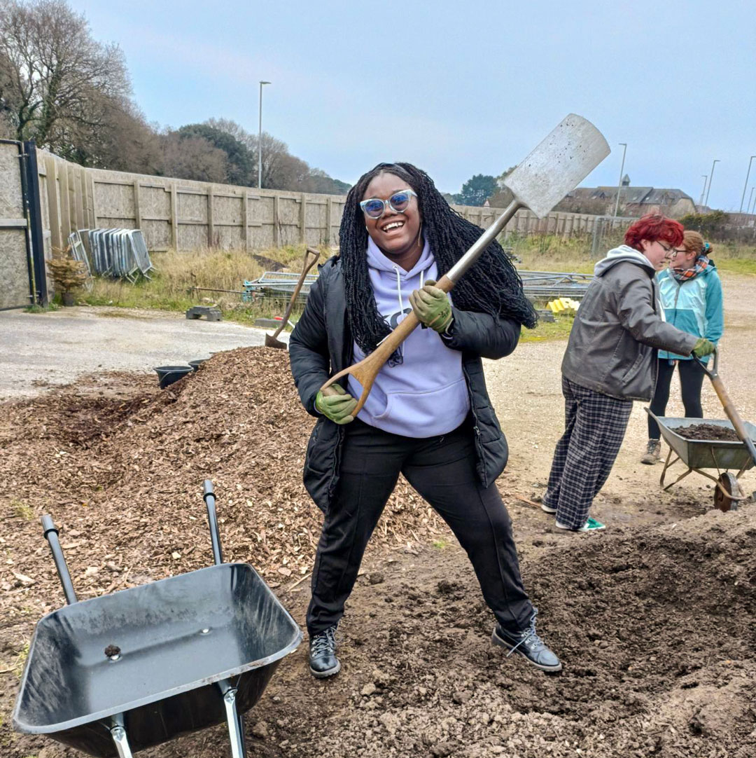 SUBU volunteer at the community garden