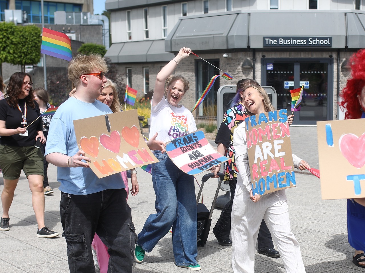 A Trans rights parade on Talbot Campus, with students holding hand crafted signs.