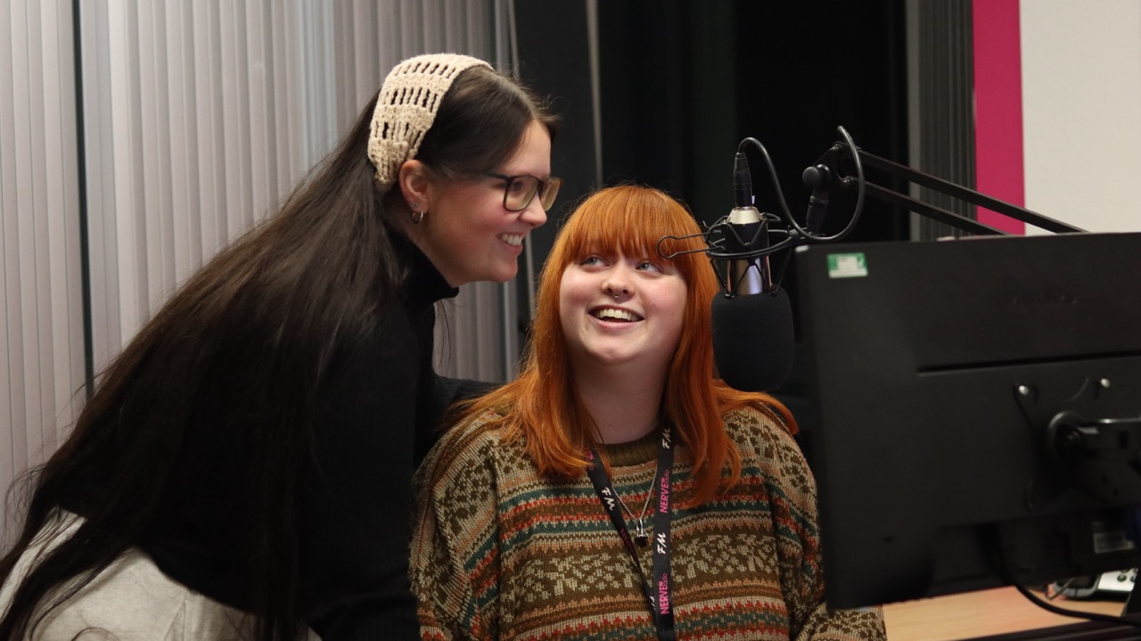 Two students recording in a radio studio.