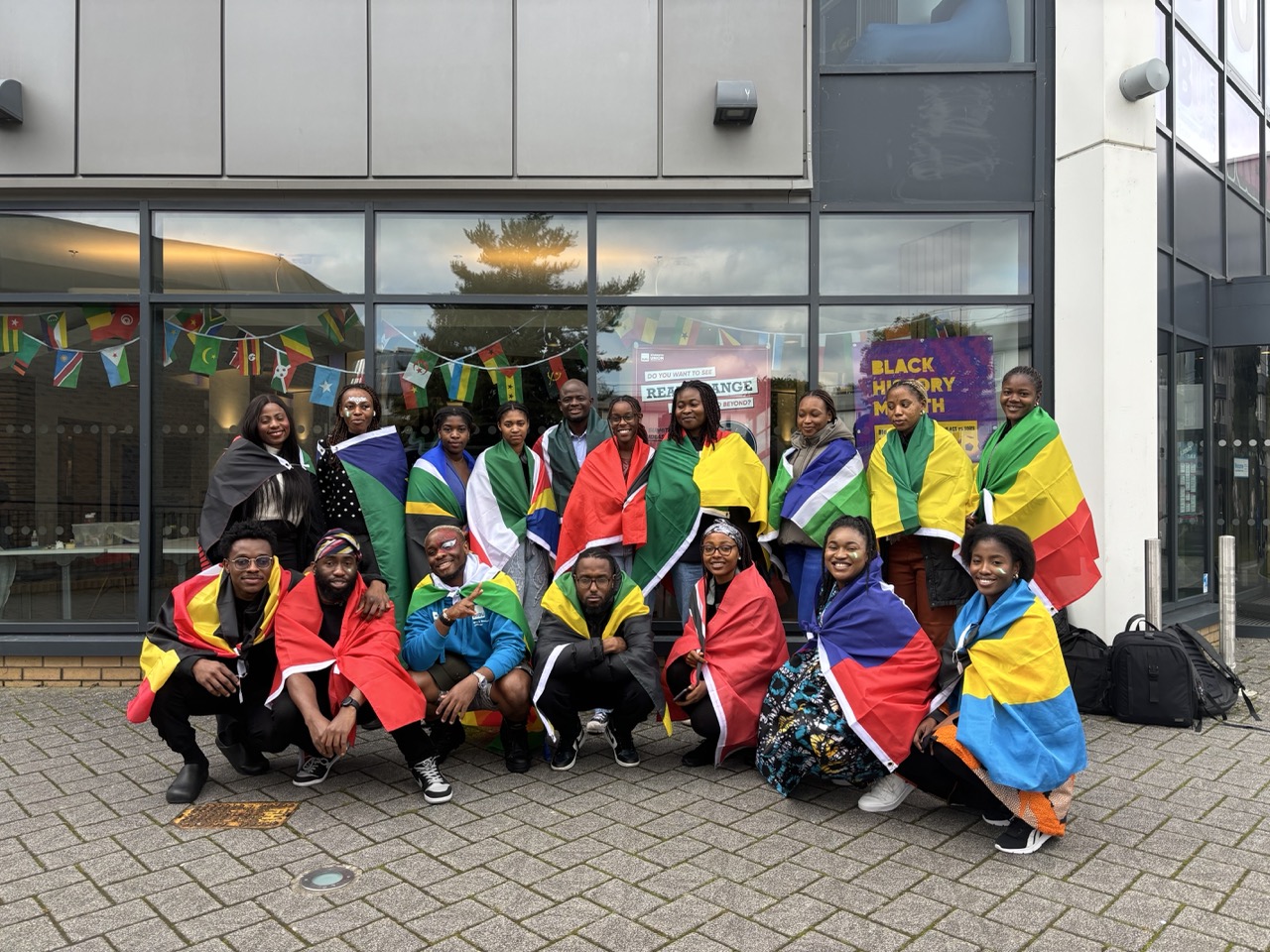 A group of students with cultural flags.