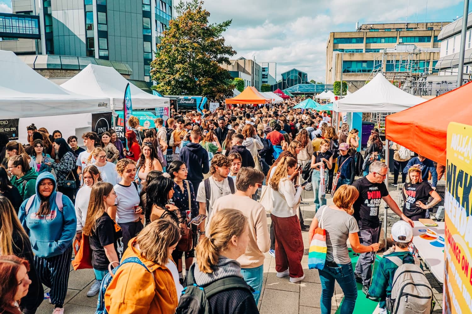 Busy crowd shot at Bournemouth University campus with stalls