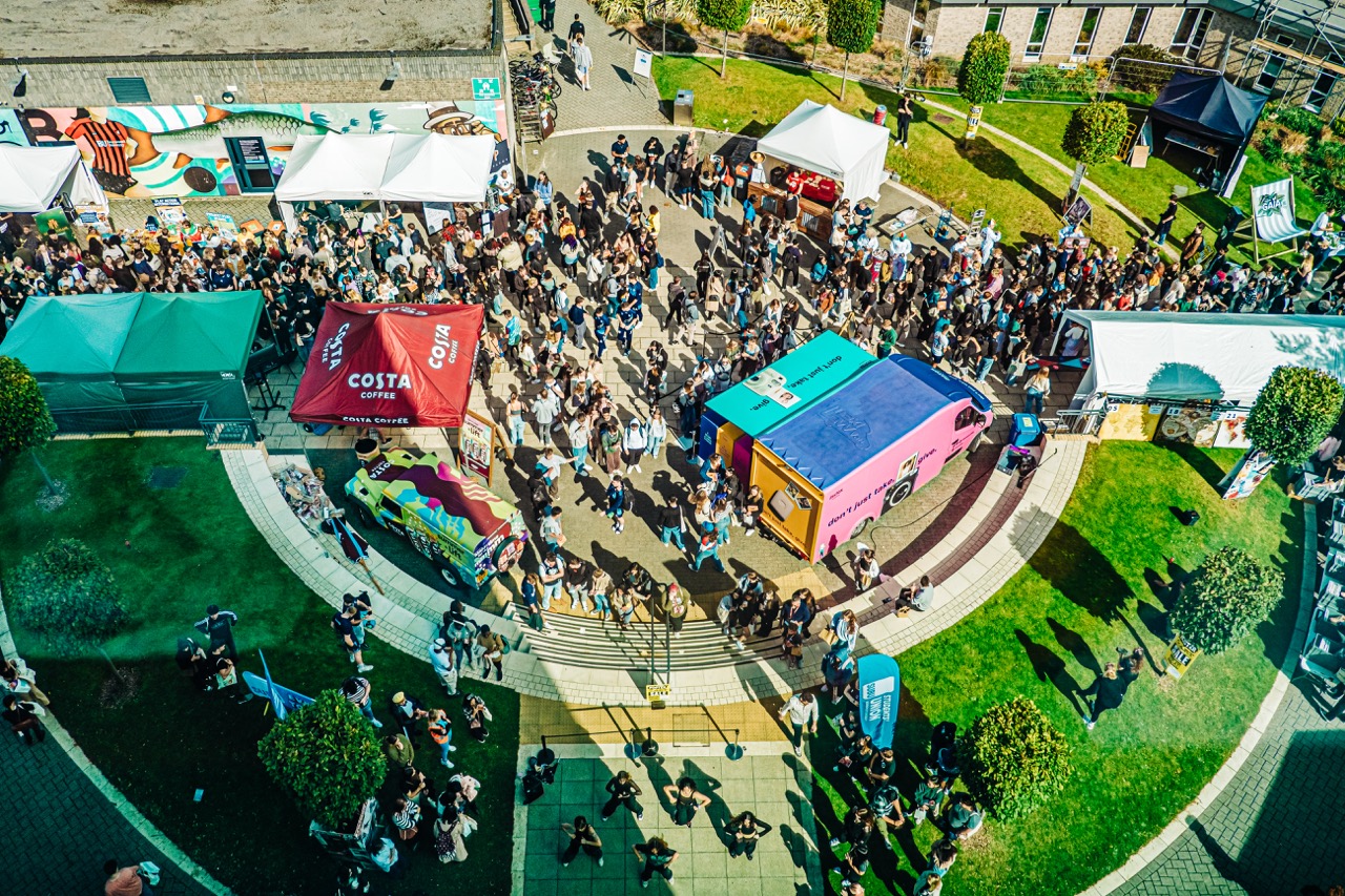 Busy courtyard during SUBU's Freshers Fair with a variety of stalls